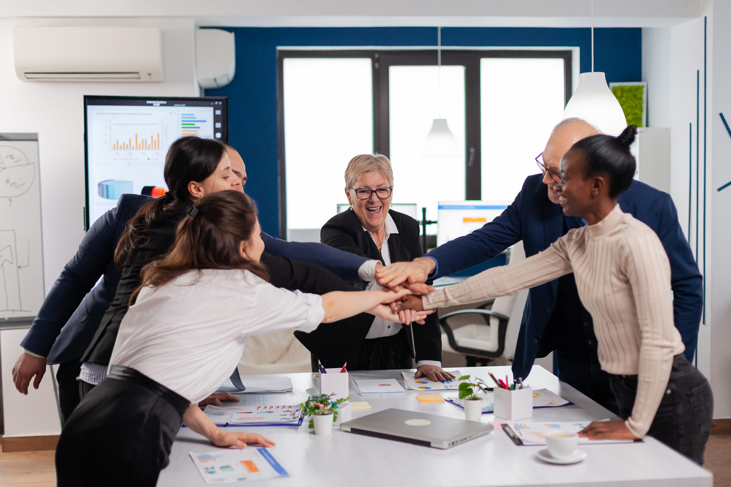 a group of people putting their hands together